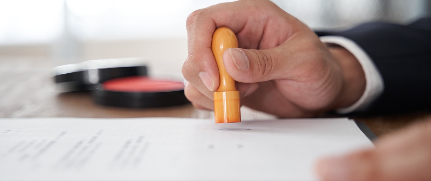 A Japanese male businessman who stamps his corporate seal on a document
